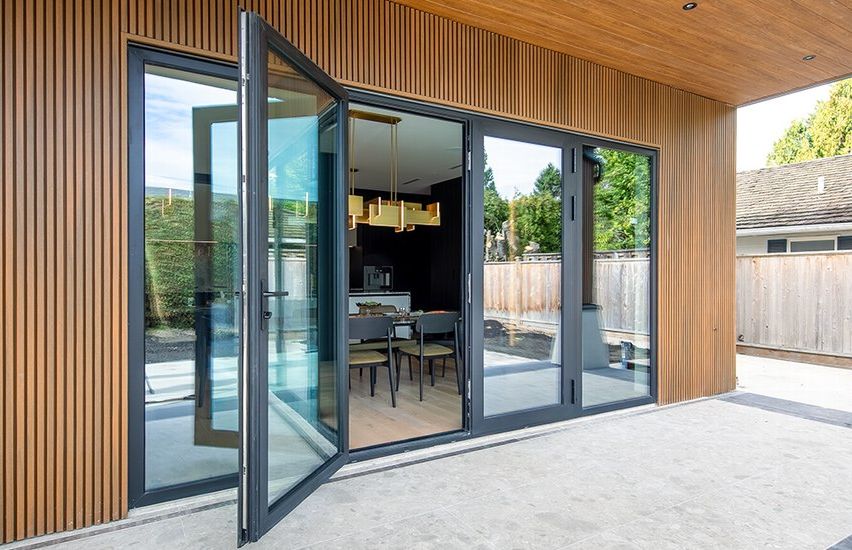 Langton Road residence, Richmond. Reynaers French doors with twin fixed sidelites onto the patio, under a cedar soffit.